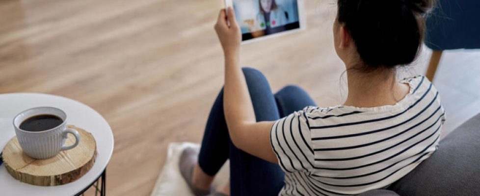 Young woman having a video conference with her doctor