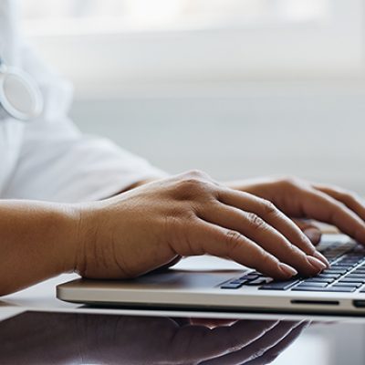 Female doctor working with her laptop