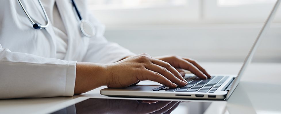 Female doctor working with her laptop