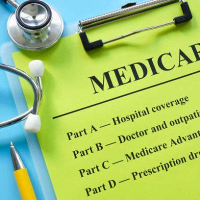 Papers about types of medicare insurance and a stethoscope.