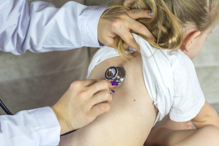 Clinician providing care to a child in a school health setting